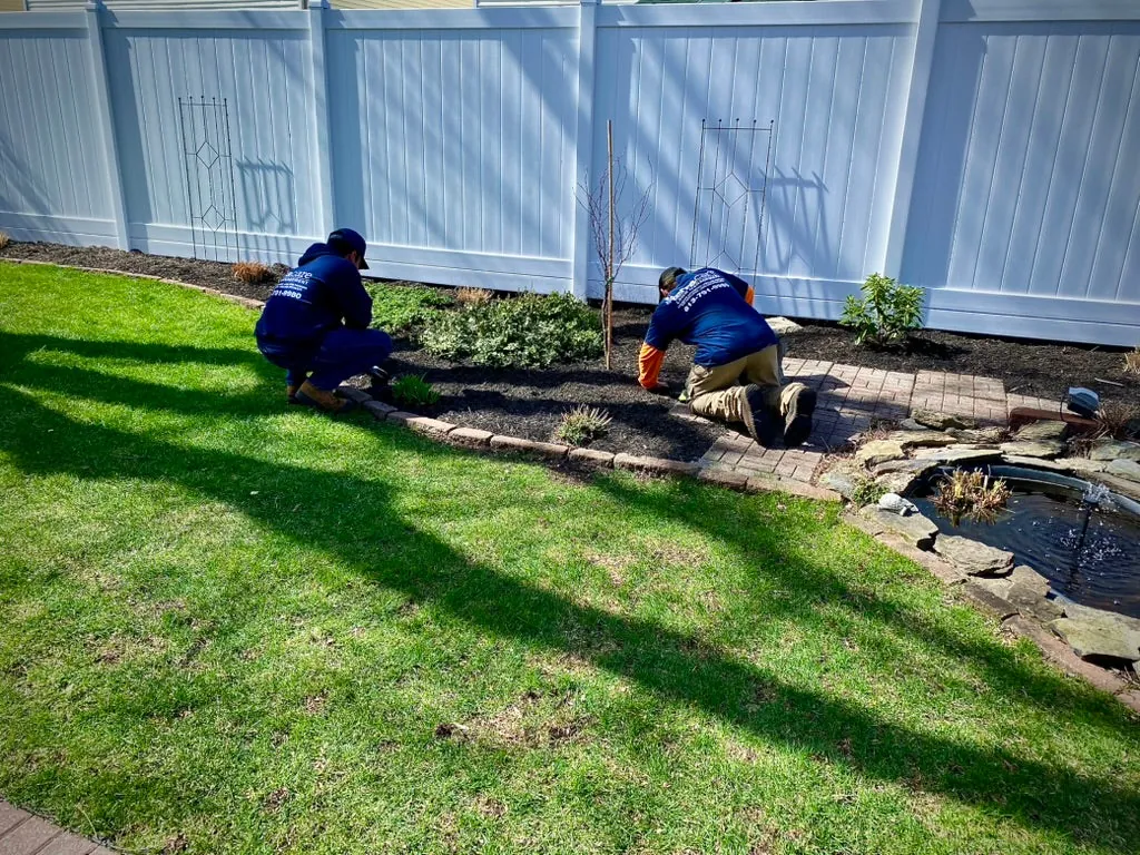 TerraCare crew installing a garden bed and water feature
