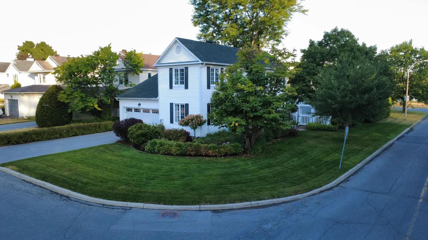 Manicured corner-lot lawn and landscaping in Manotick